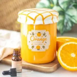 Quemador de aceite y calentador de cera en tarro de mermelada de naranja
