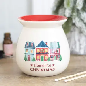 Quemador de cera Home for Christmas en una escena navideña decorativa